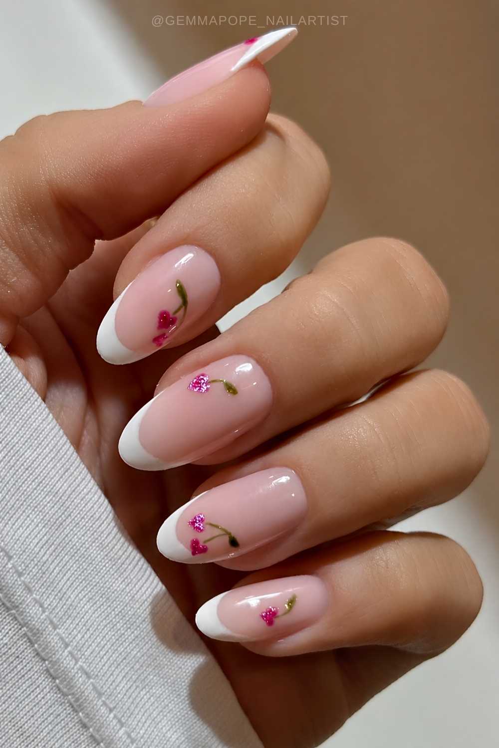 White French nails with pink heart shaped cherries
