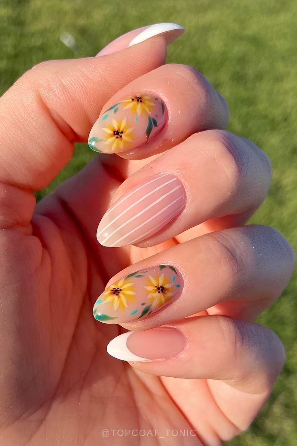 White French nails with stripes and sunflowers