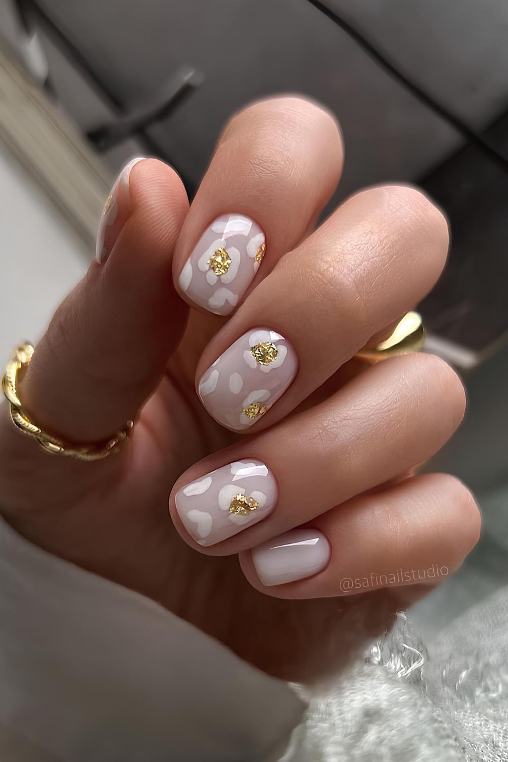 White leopard print mani with gold accents