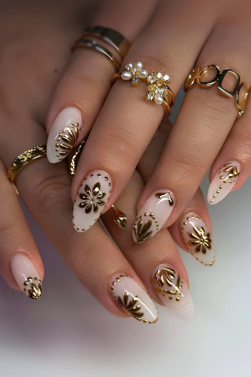 White nails with gold chrome flower art