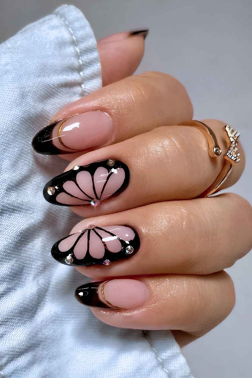 Black French nails with butterflies and gems