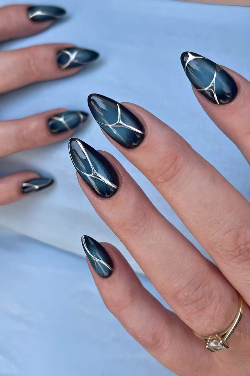 Black and blue aura nails with line art