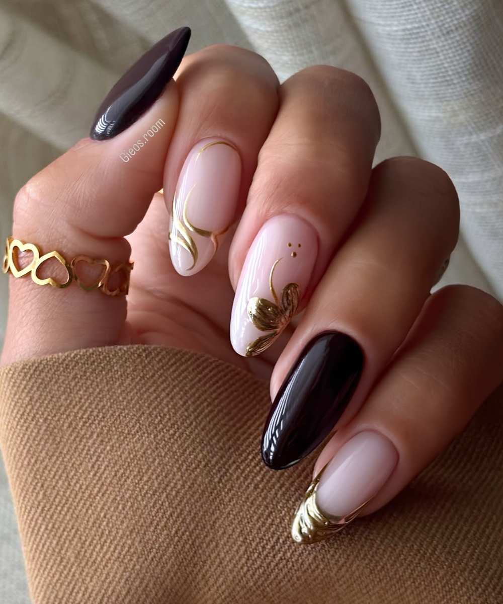 Black and gold nails with swirls and flowers