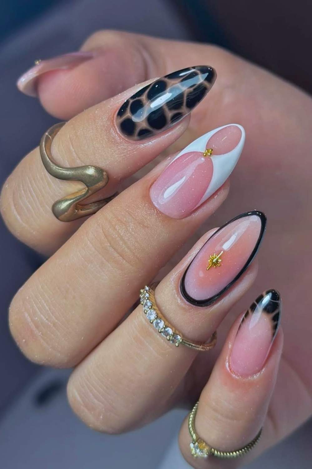 Black and white nails with animal print and gold details