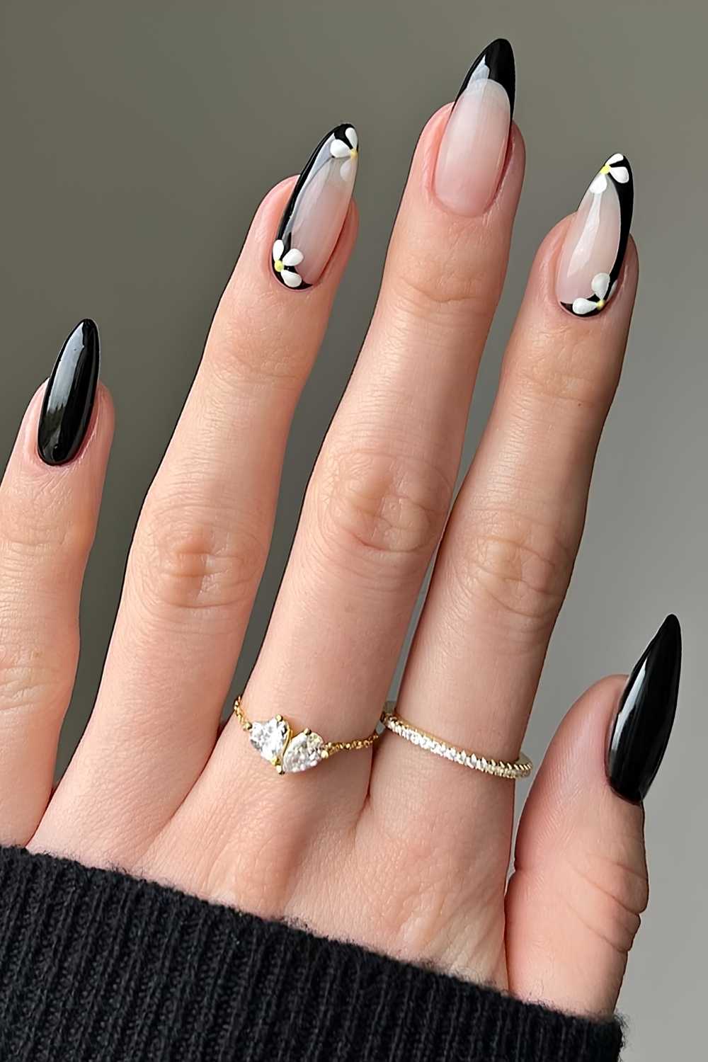 Black manicure with daisy flower art