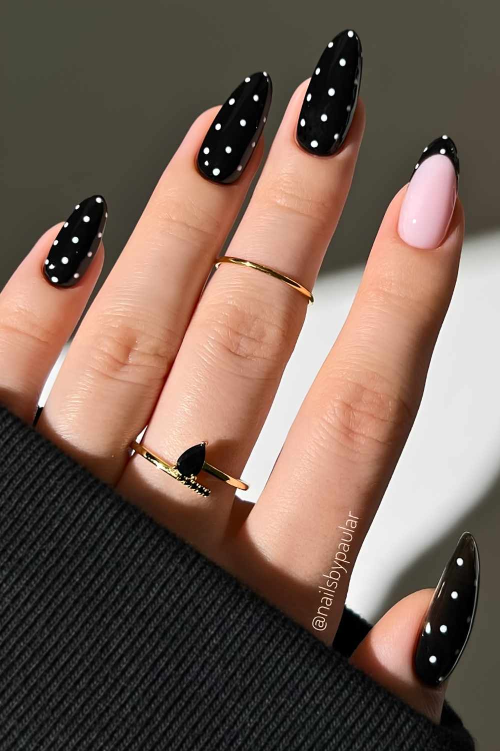 Black manicure with white polka dots