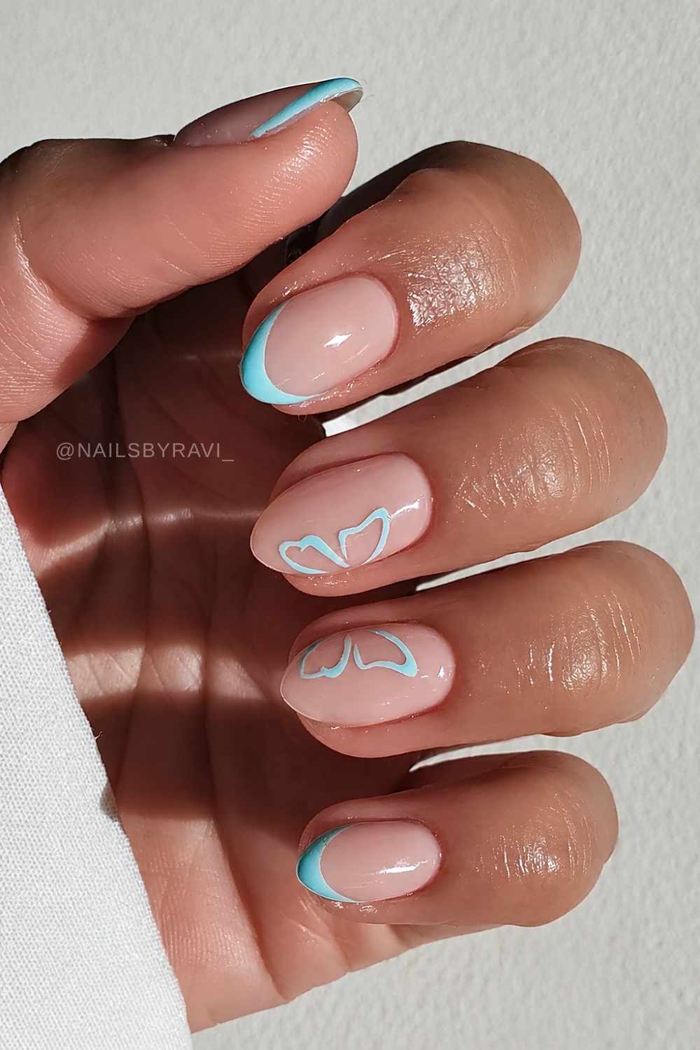 Blue French mani with butterfly wing art