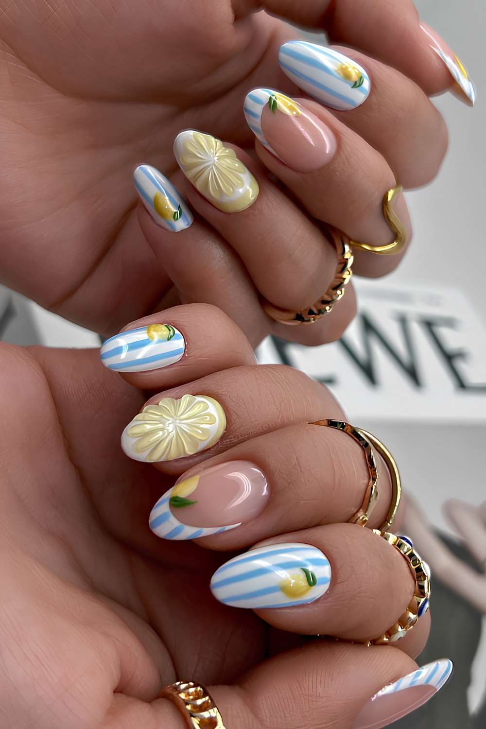 Blue and white striped nails with lemon art