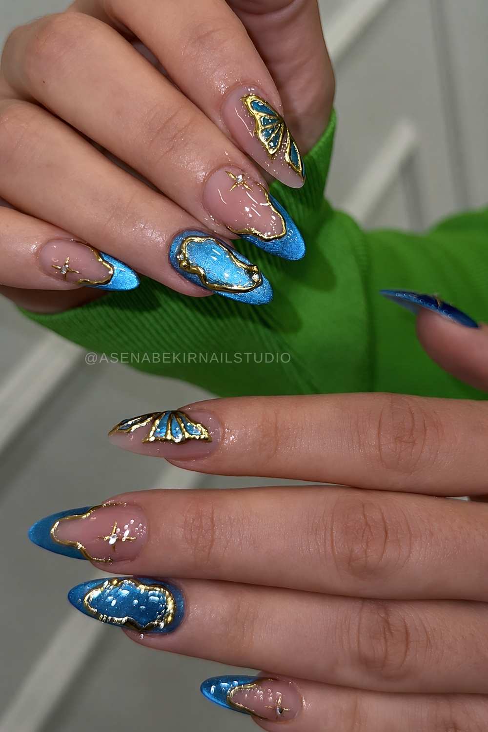 Blue cat eye mani with gold and butterfly art