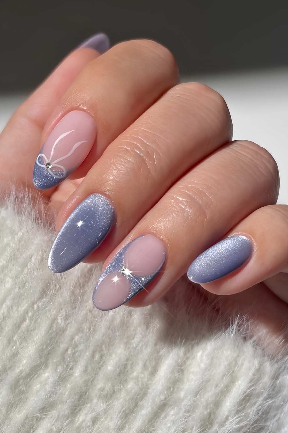 Blue cat eye nails with bows and gems