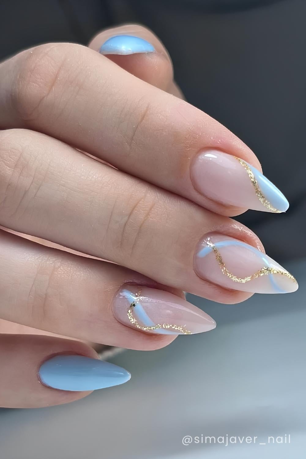 Blue nails with swirl and gold glitter details