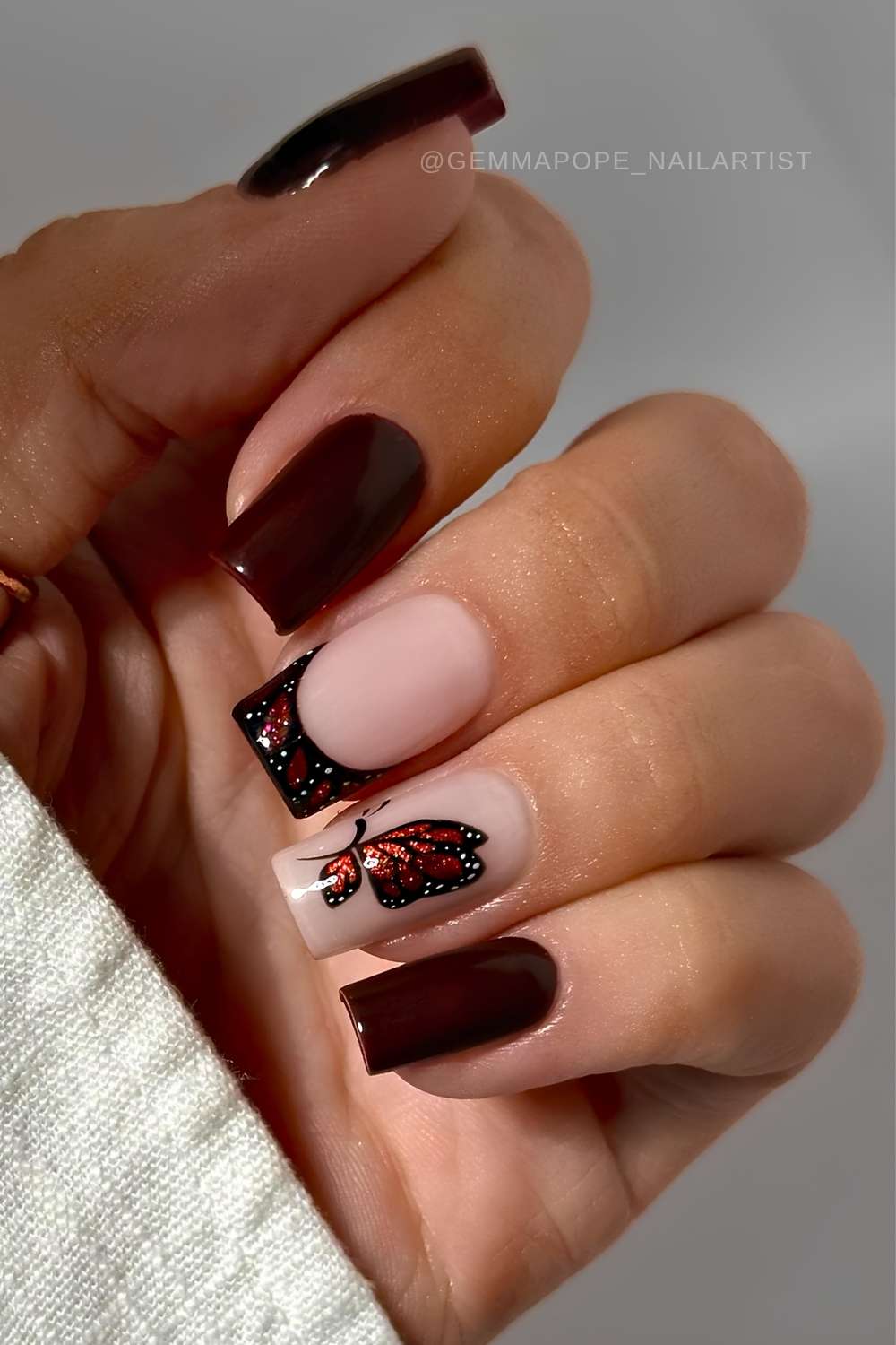 Burgundy nails with accent butterfly art