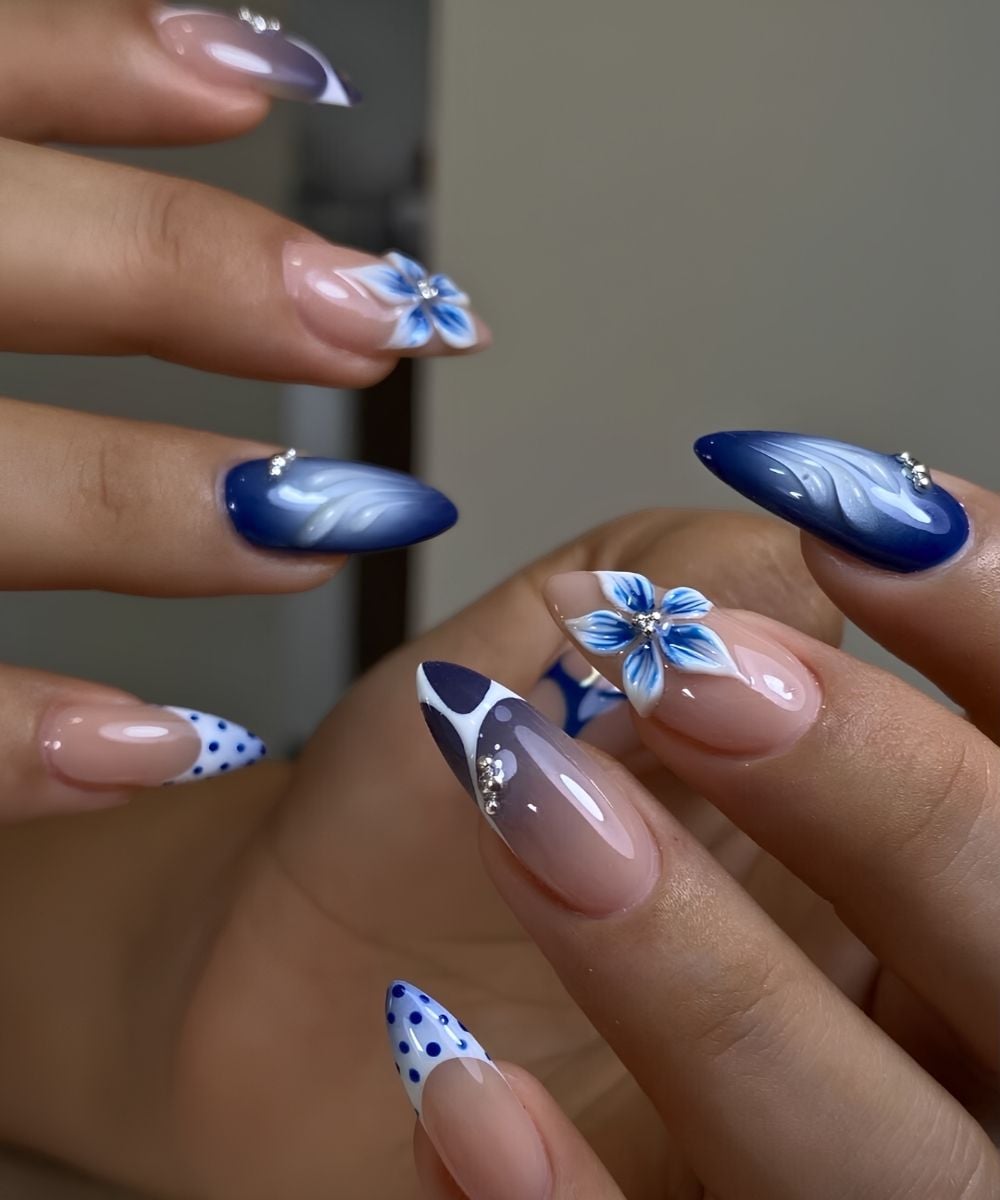 Dark blue and white nails with flowers and dots