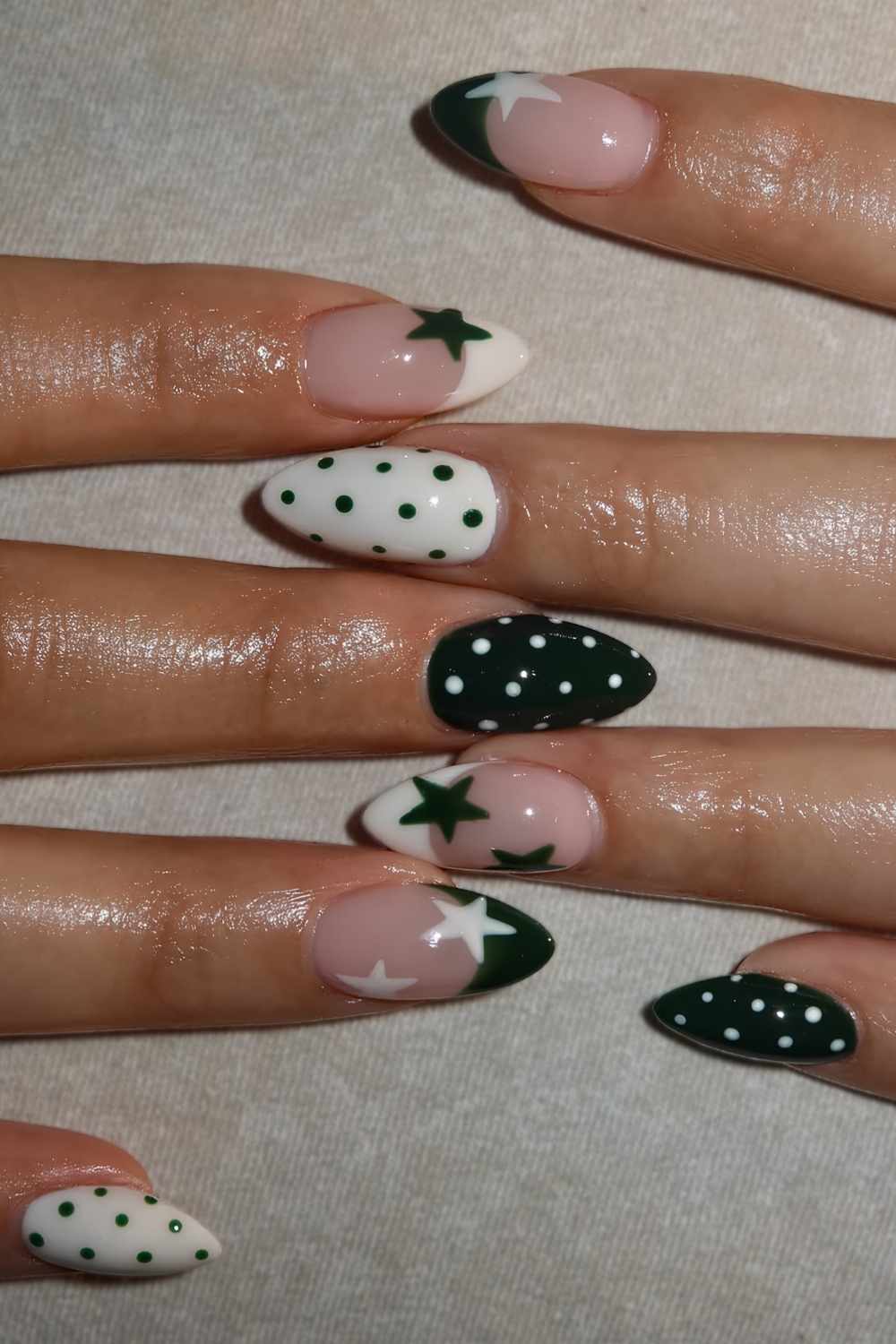 Dark green and white nails with stars and dots