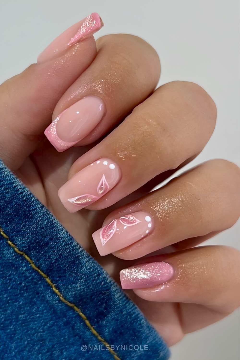 Glittery pink nails with butterfly wing art