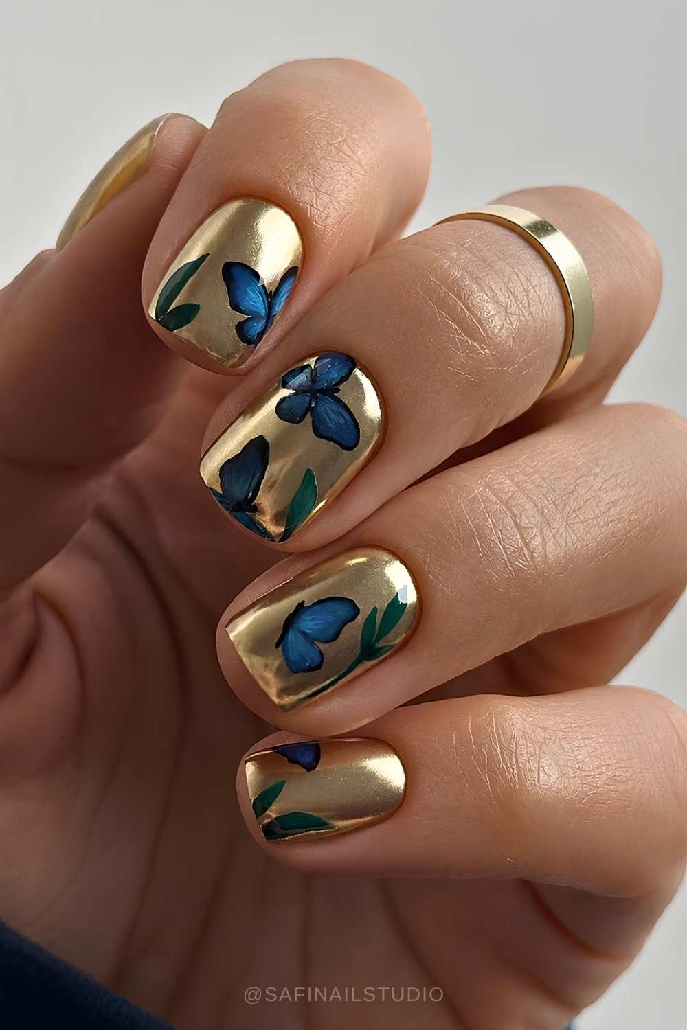 Gold chrome mani with accent blue butterflies
