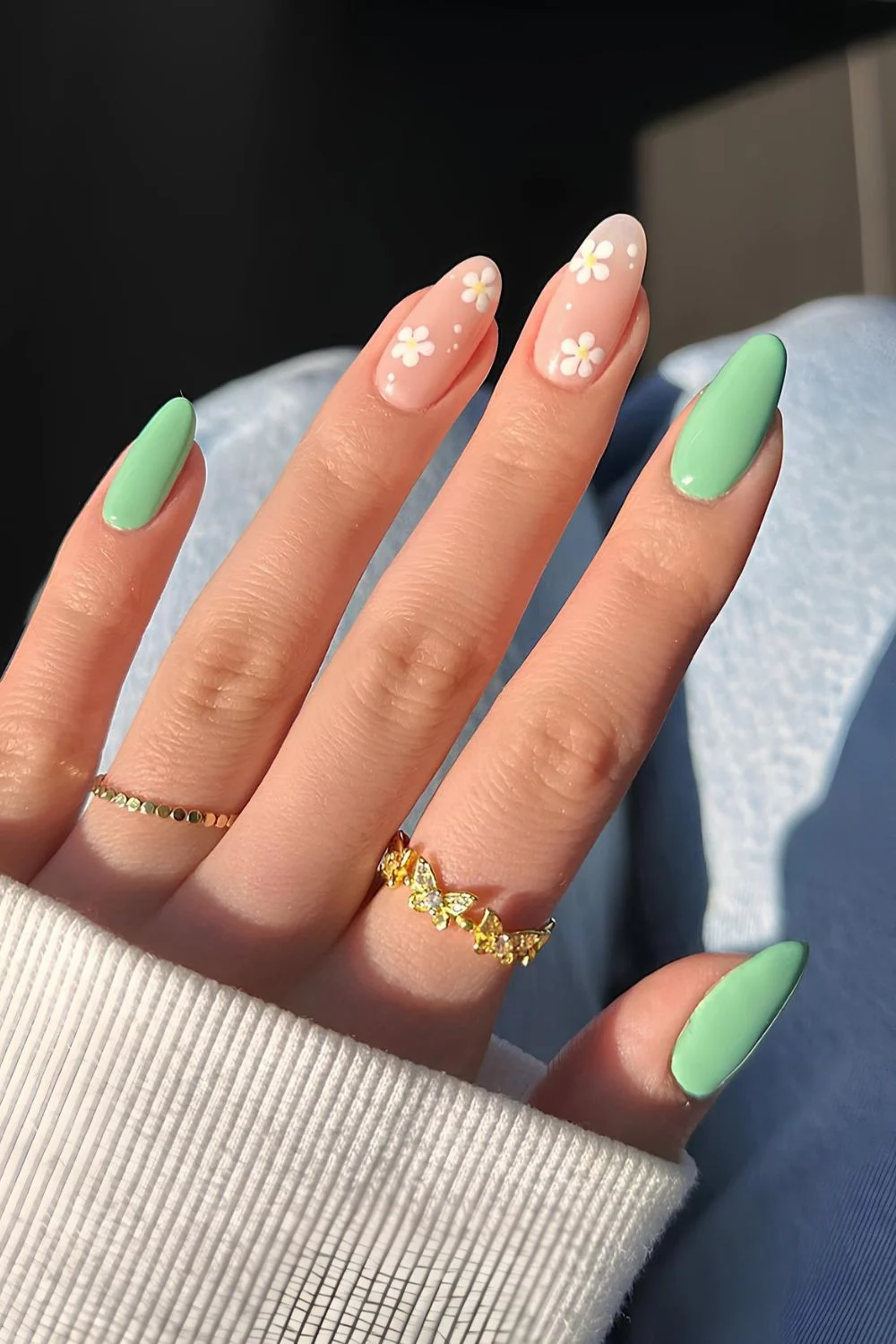 Green and neutral nails with white daisies