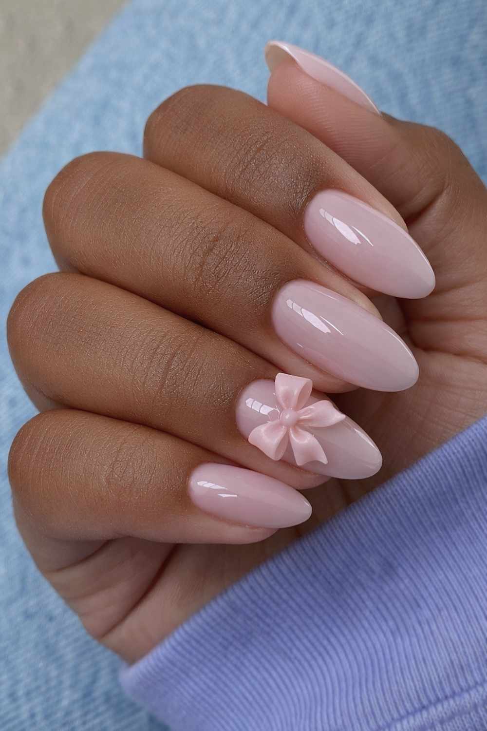 Light pink nail with textured bow detail