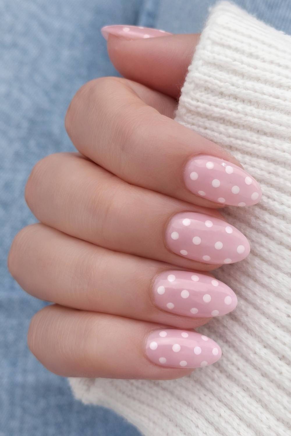Light pink nails with white polka dots
