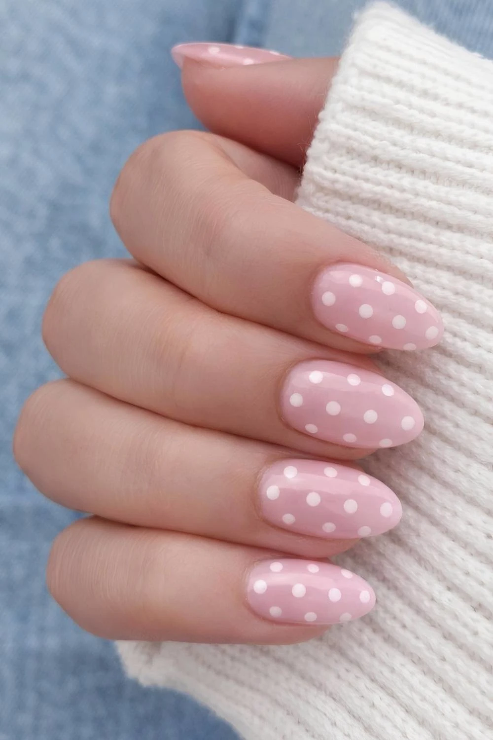 Light pink nails with white polka dots