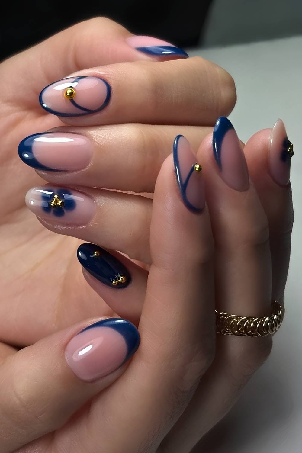 Navy blue nails with gold and floral accents