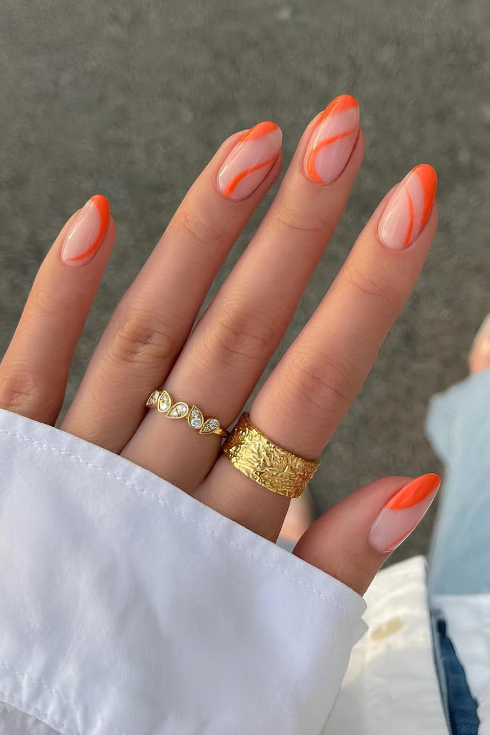 Netural nails with orange swirls