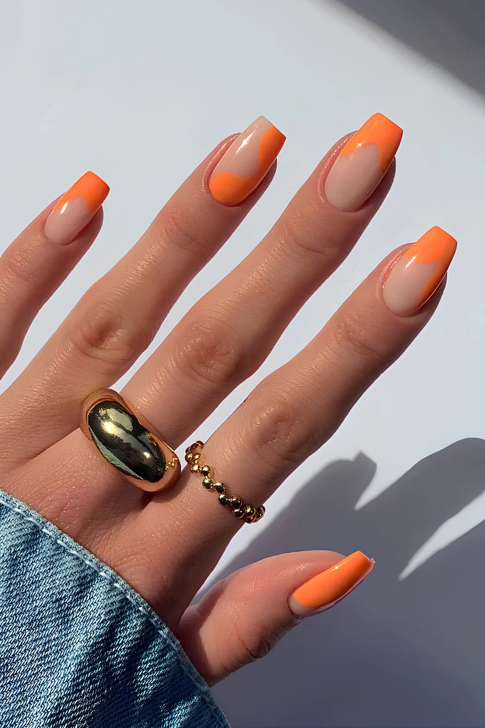 Neutral nails with orange swirls