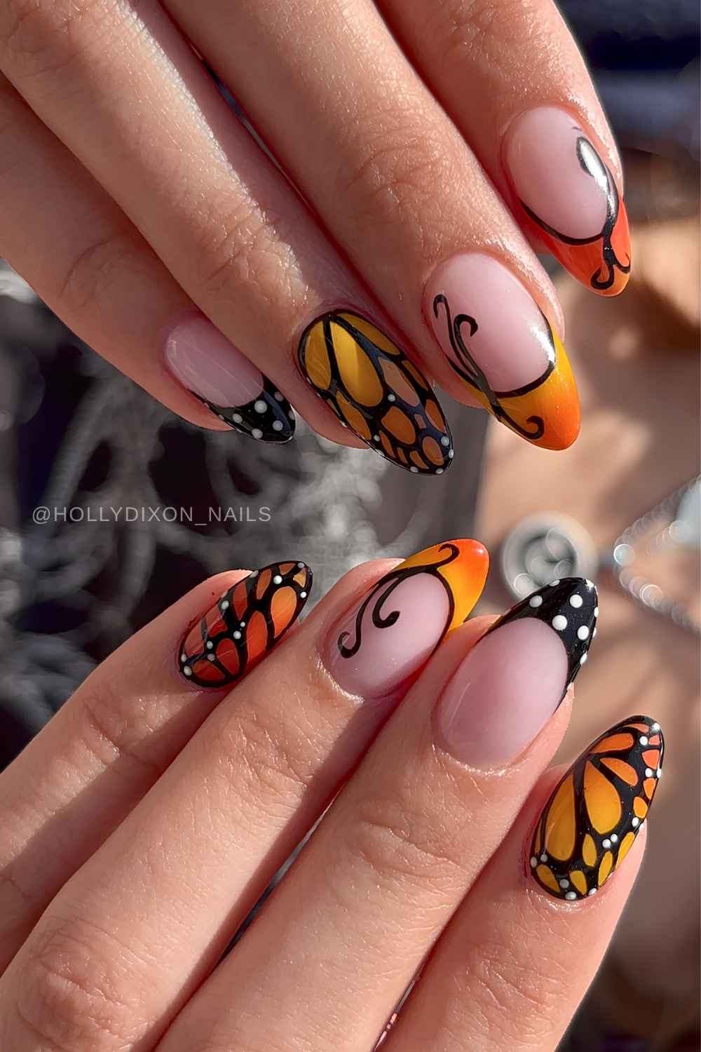 Orange and black nails with monarch butterfly art