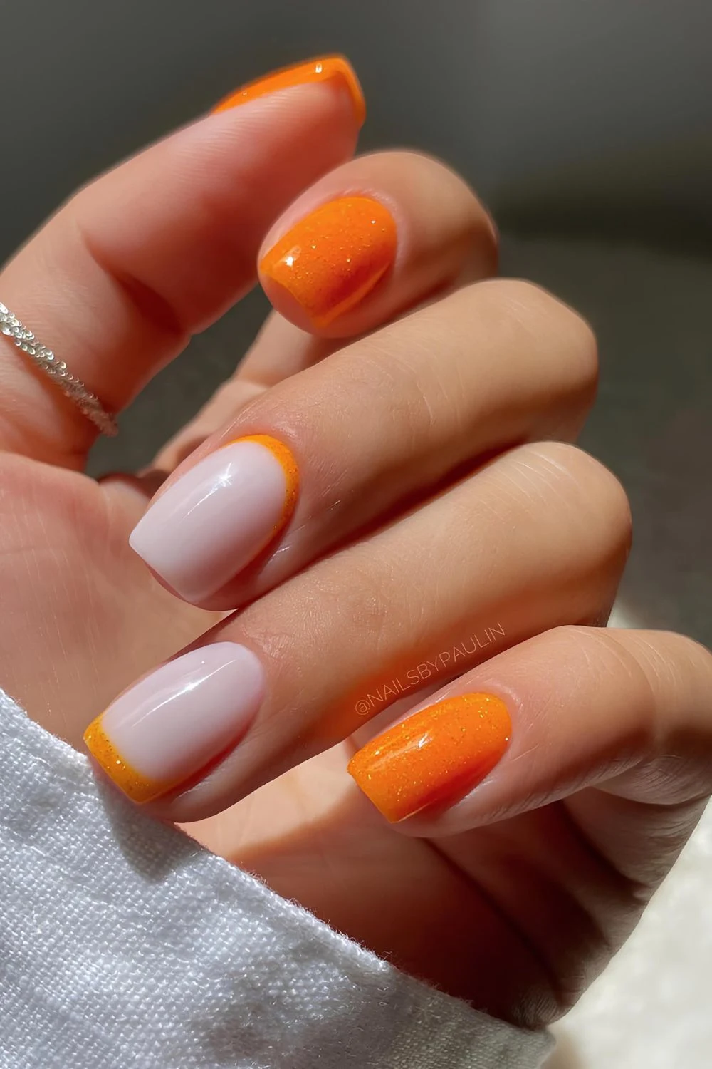 Orange glitter nails with reverse French accent