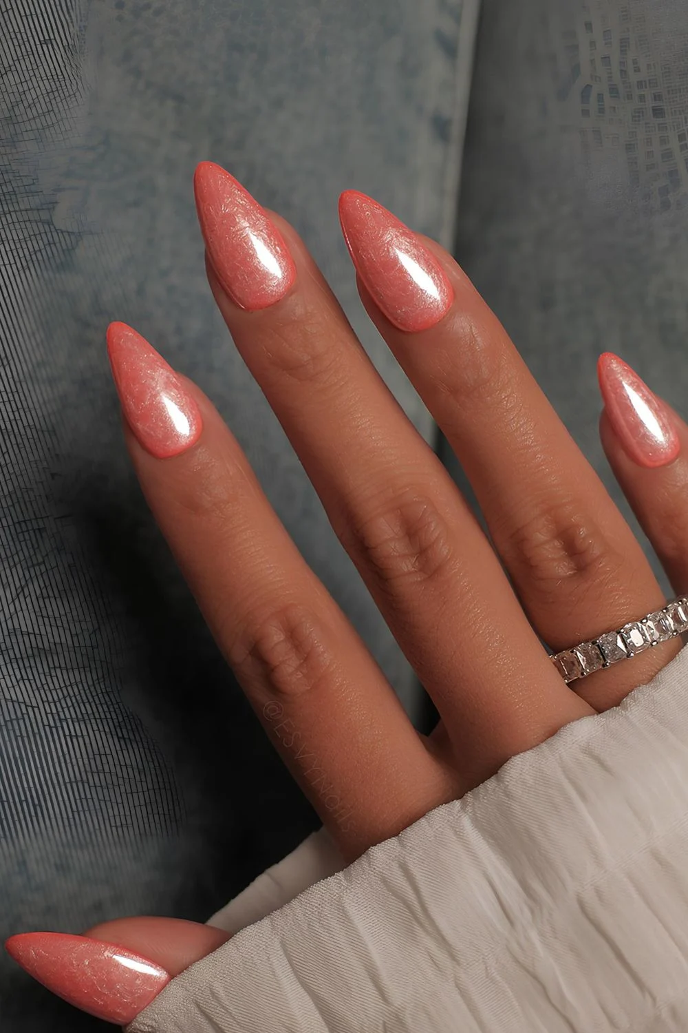 Orange pearl nails with swirly marble effect