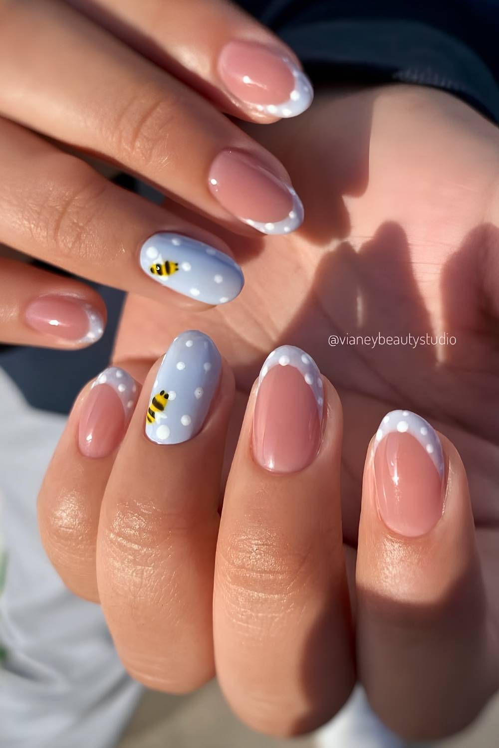 Pastel blue nails with accent bee art