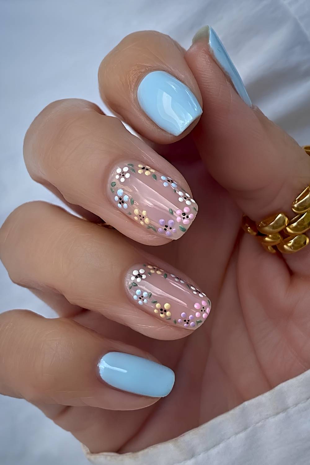 Pastel blue nails with micro floral art