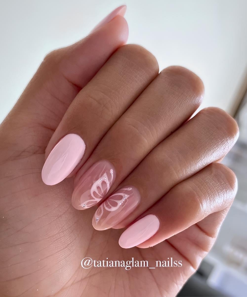 Pastel pink nails with butterfly art