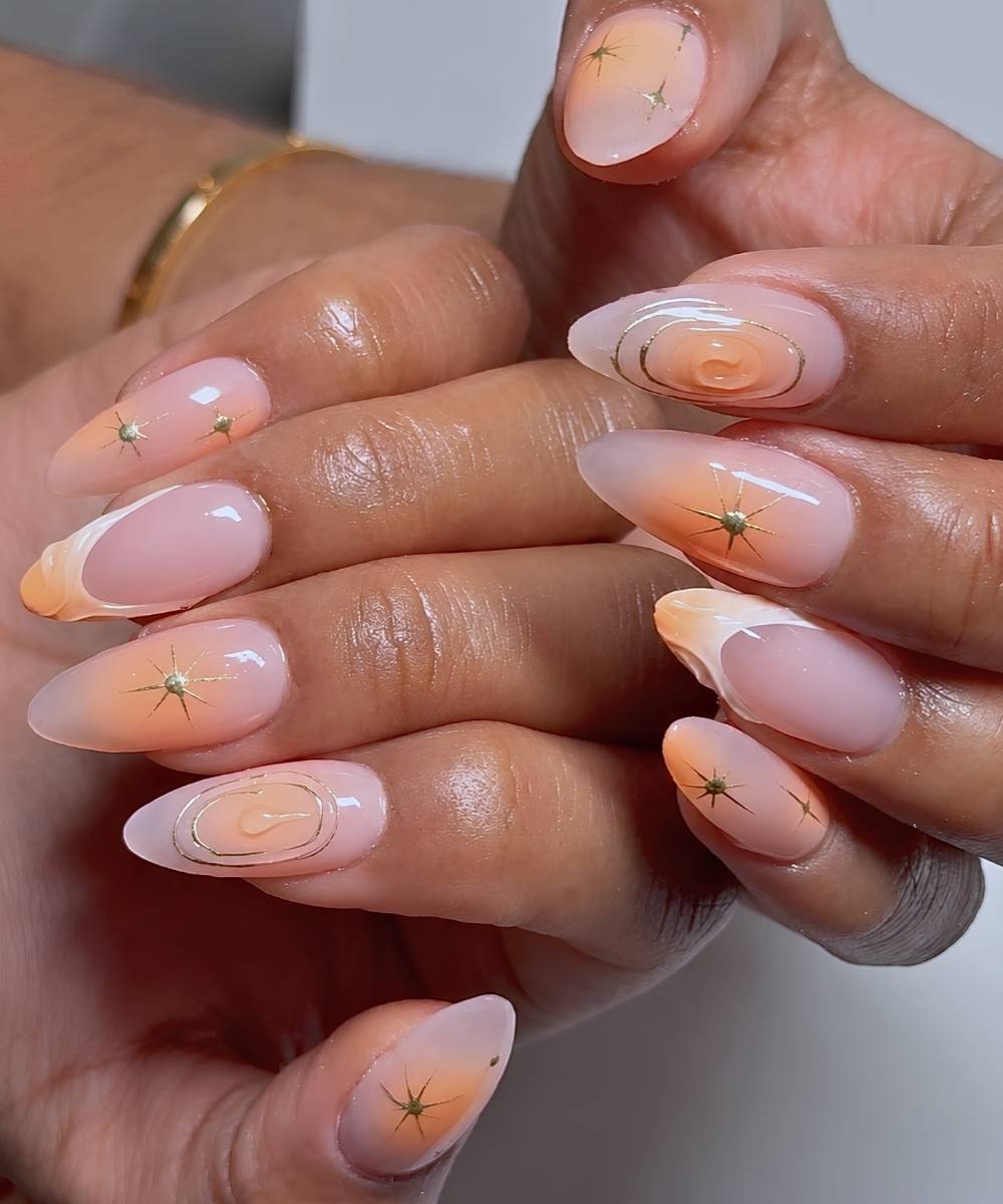 Peach nails with metallic celestial art