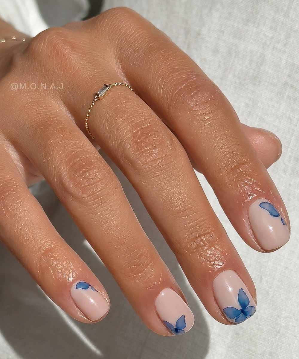 Short milky white nails with blue butterflies
