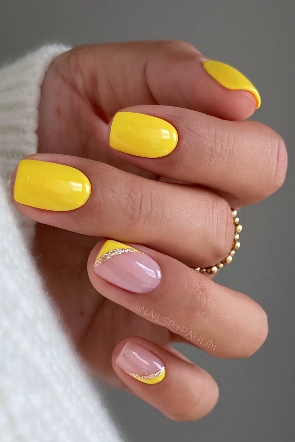 Short yellow nails with glitter accents