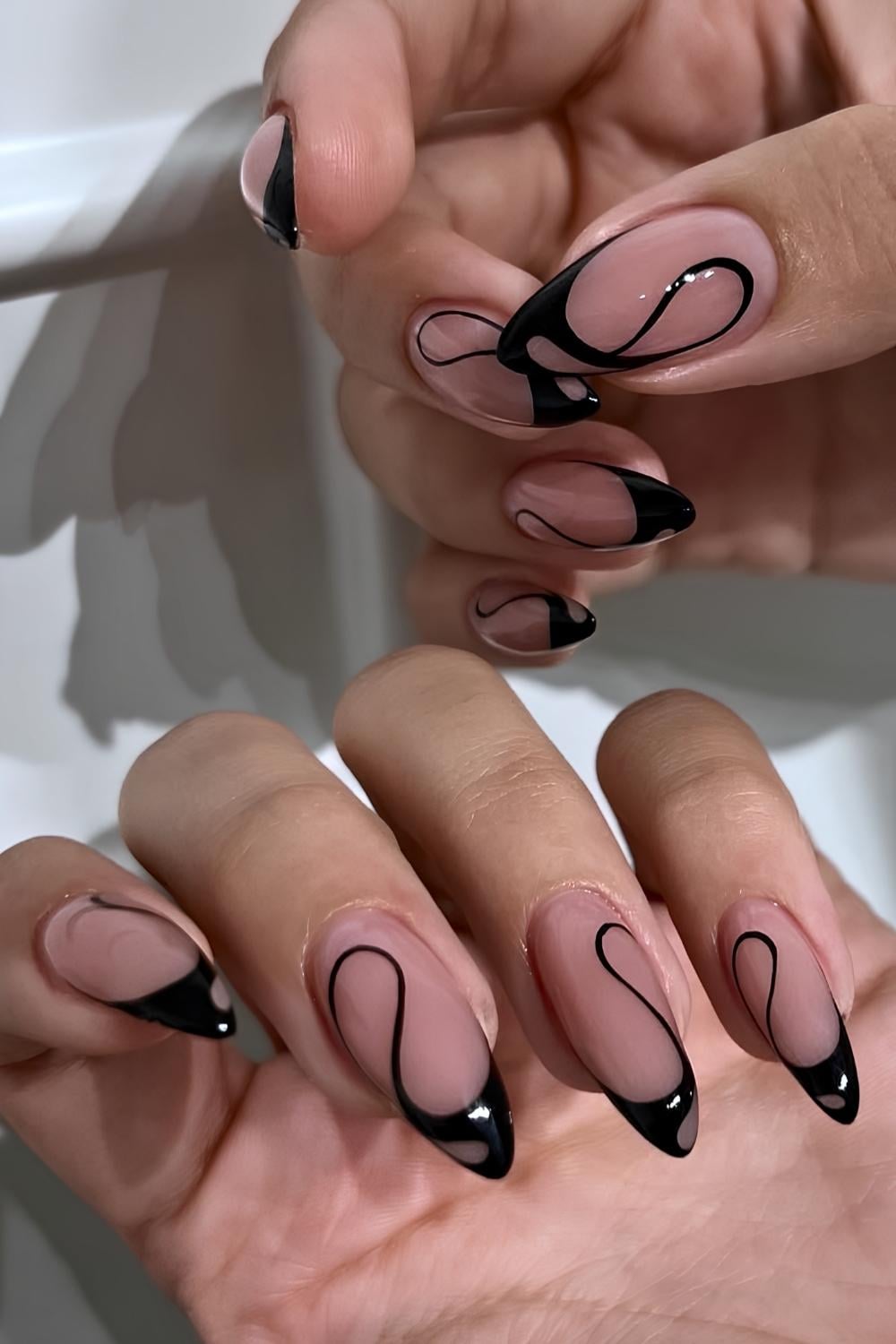 Swirly black French tip manicure