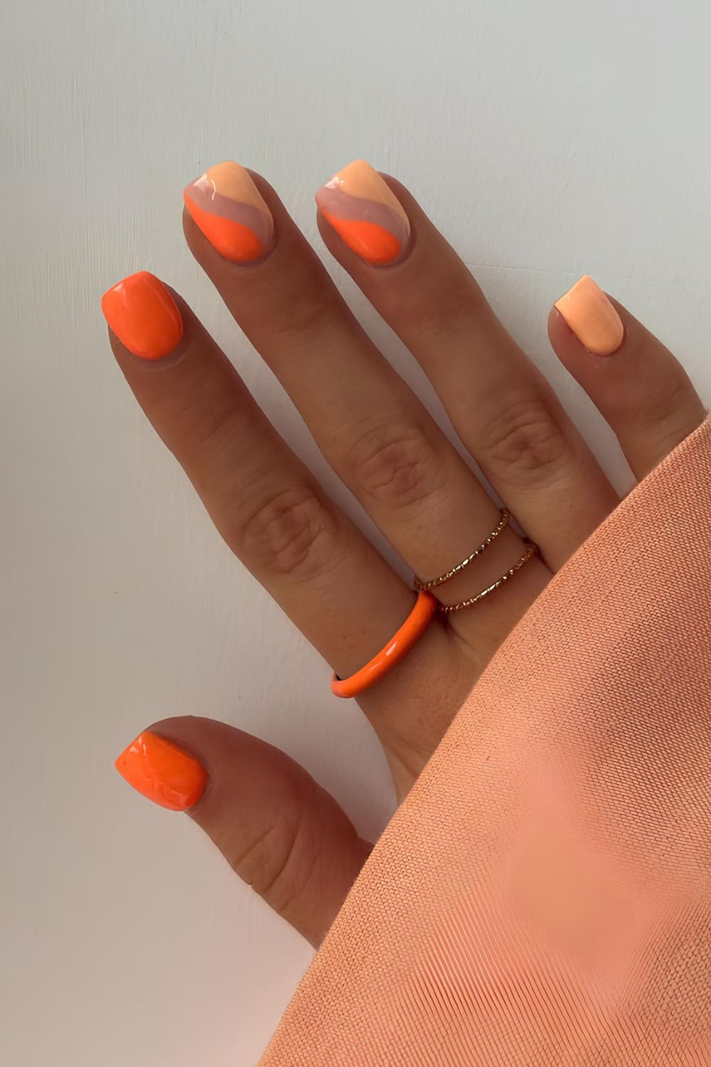 Tangerine and peach nails with swirls