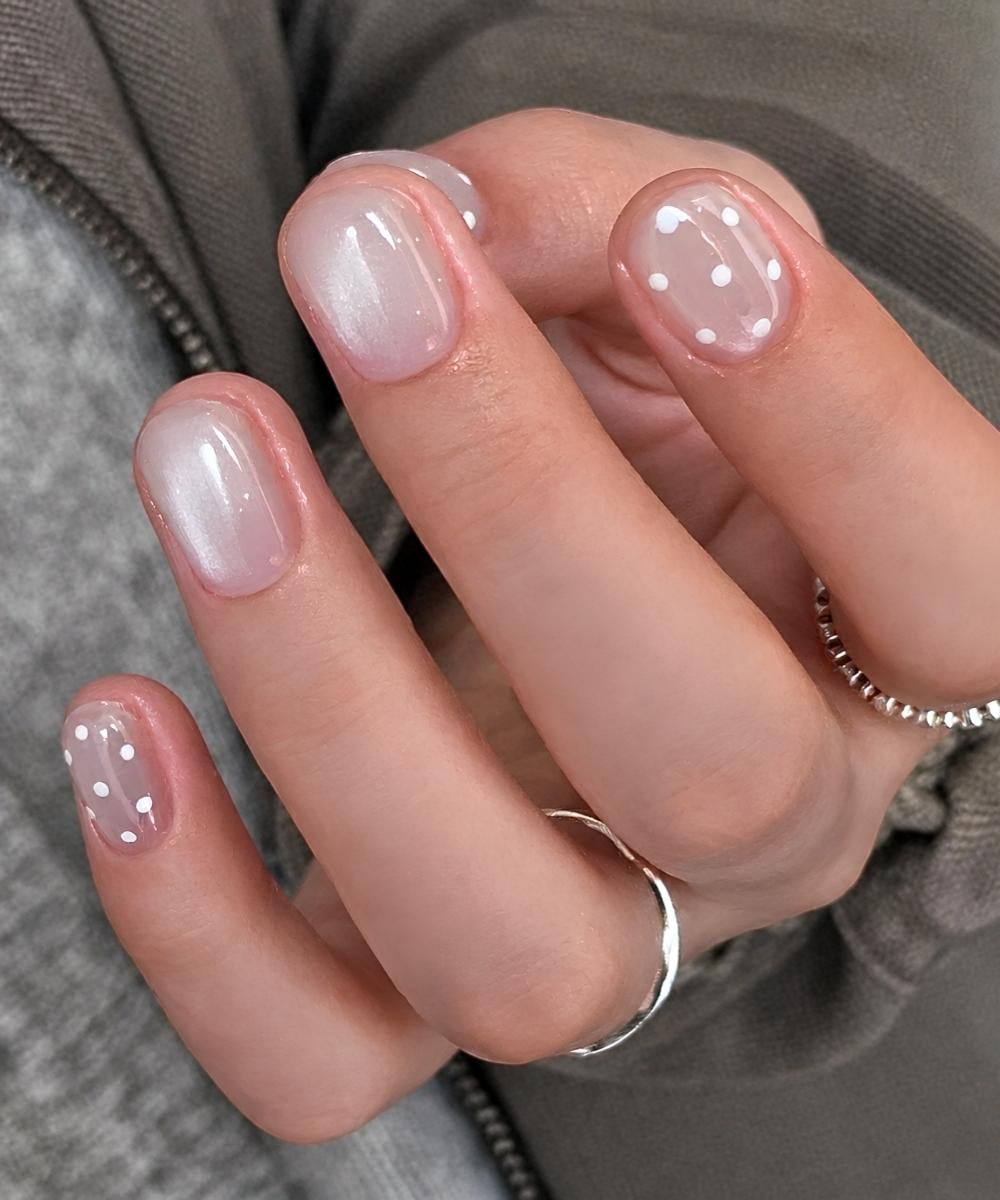 White cat eye nails with polka dots