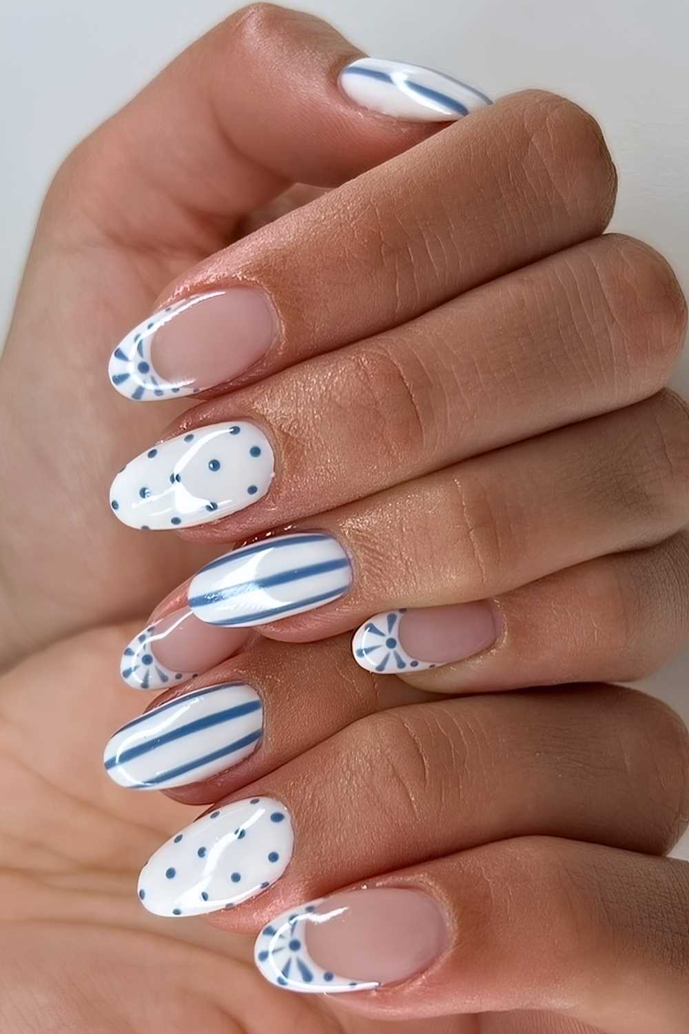 White nails with blue stripes and dots
