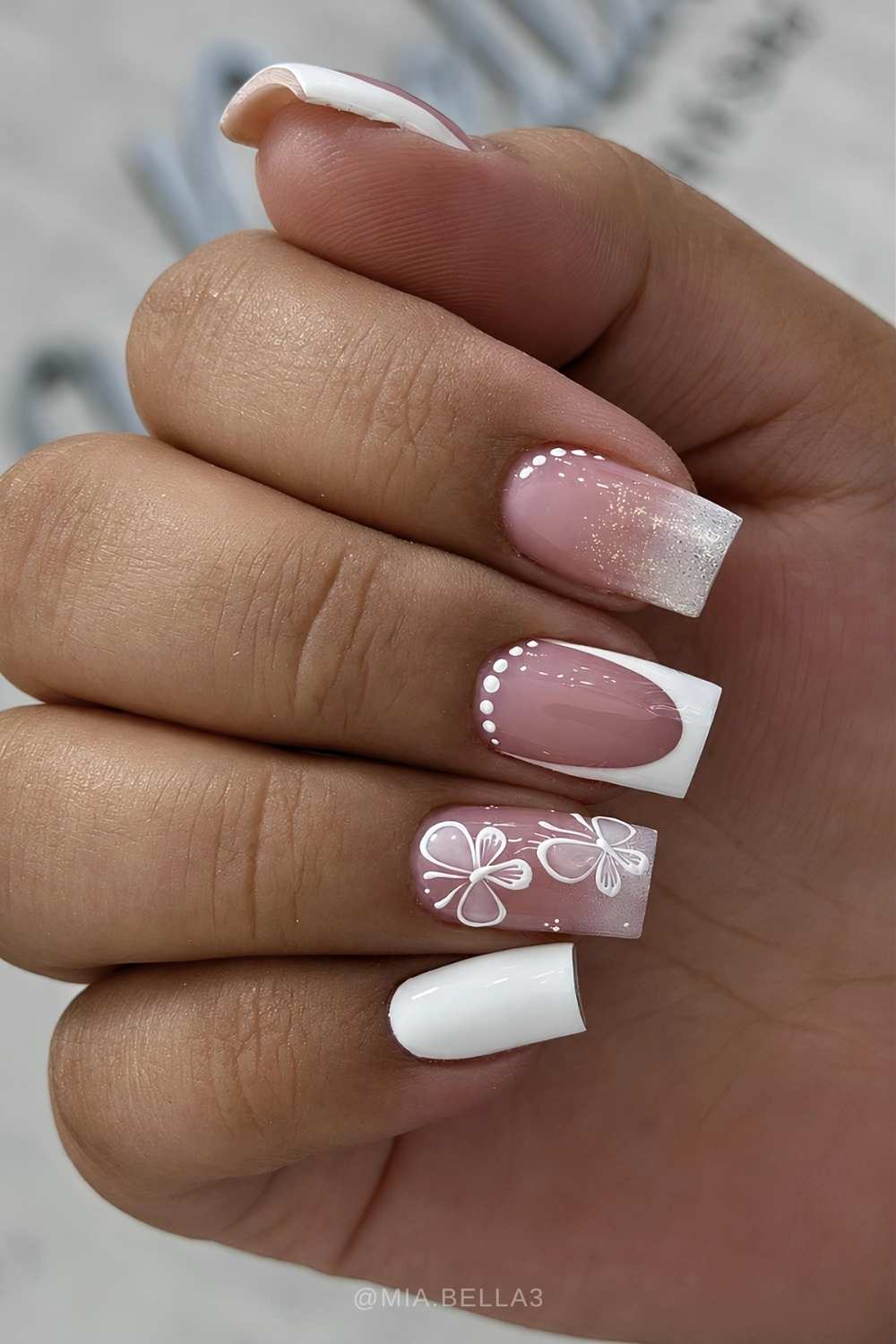 White nails with glitter and butterflies