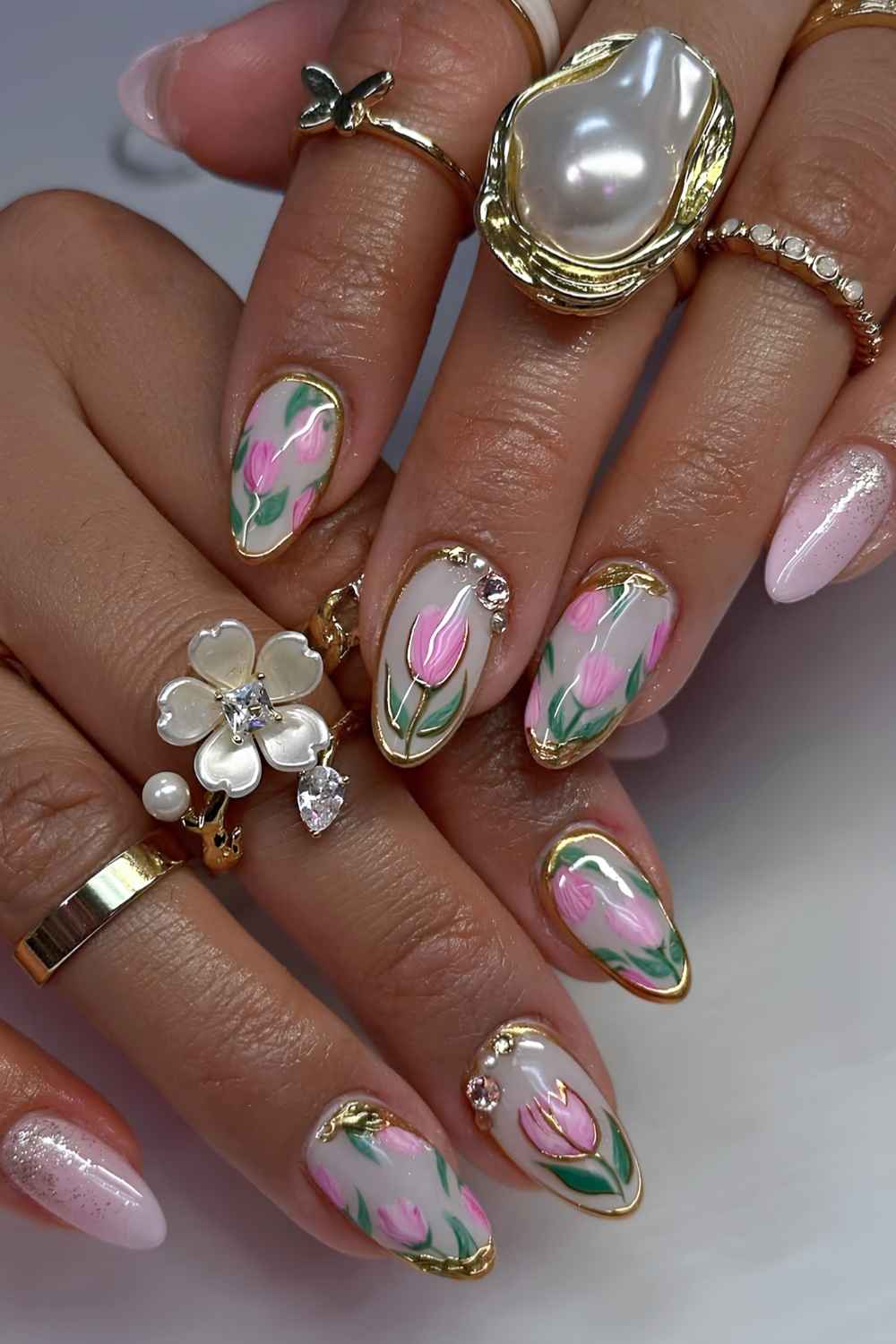 White nails with pink tulips and gold accents