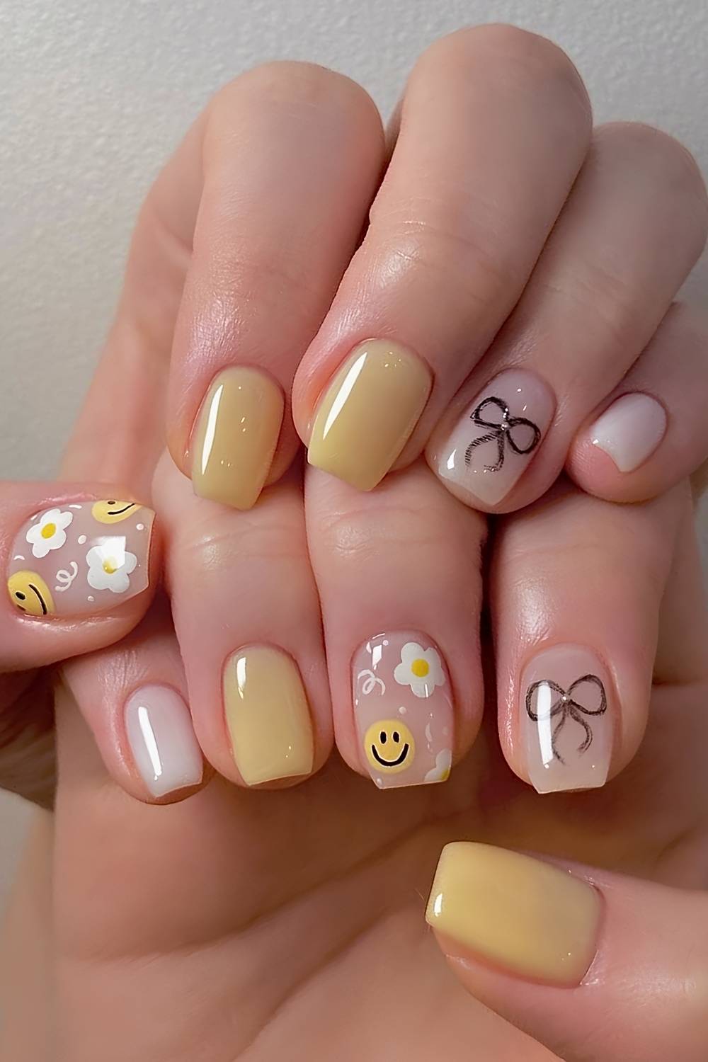 Yellow nails with bows and smiley faces