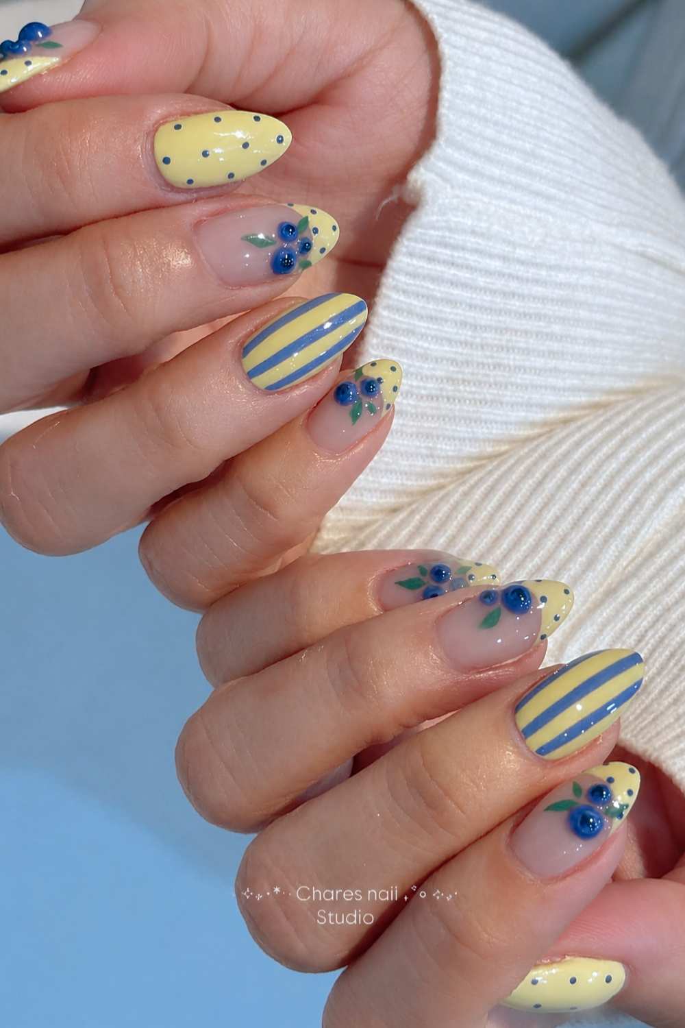 Yellow nails with stripe and bluebbery art
