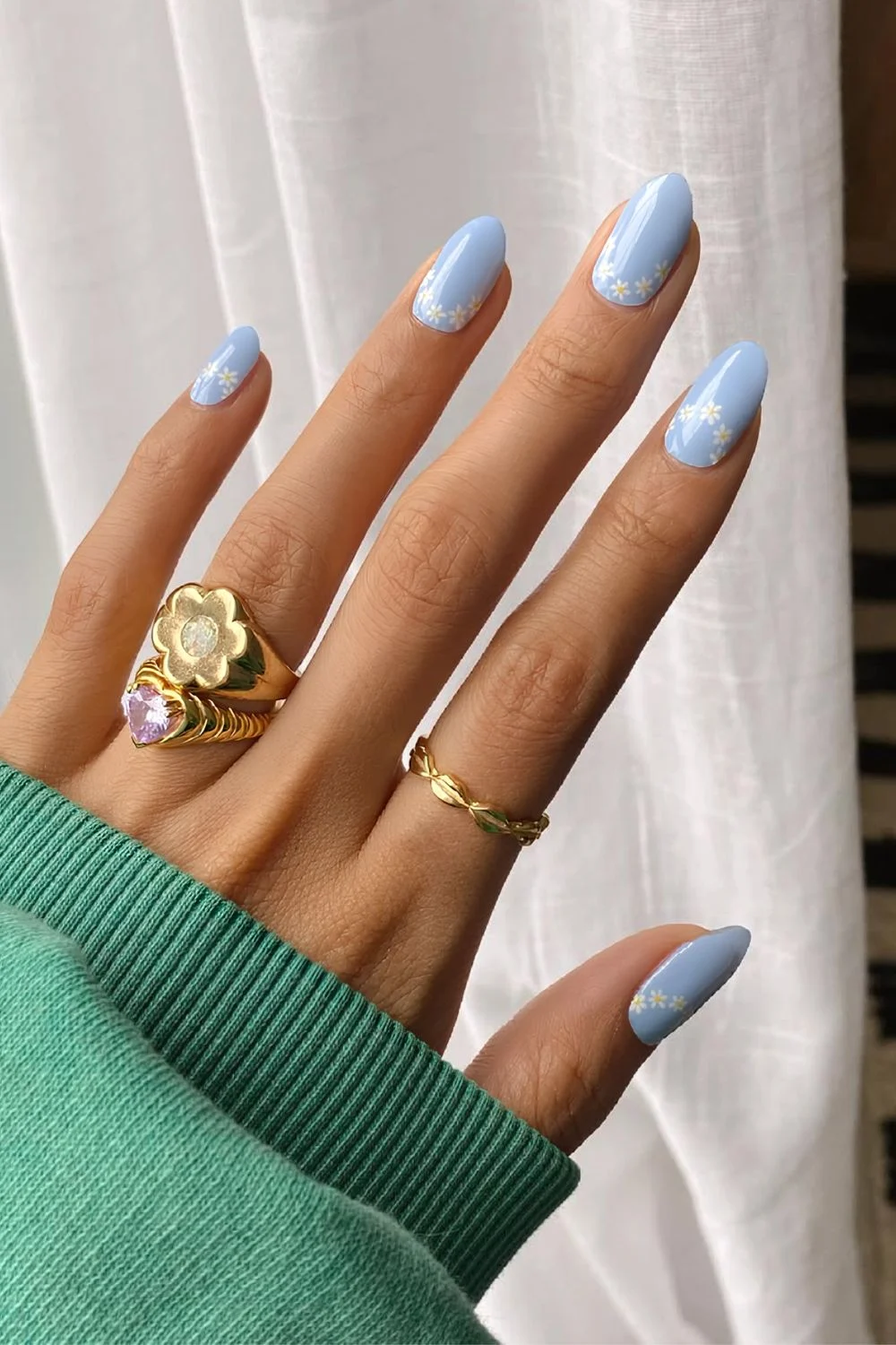 Baby blue nails with daisy accents