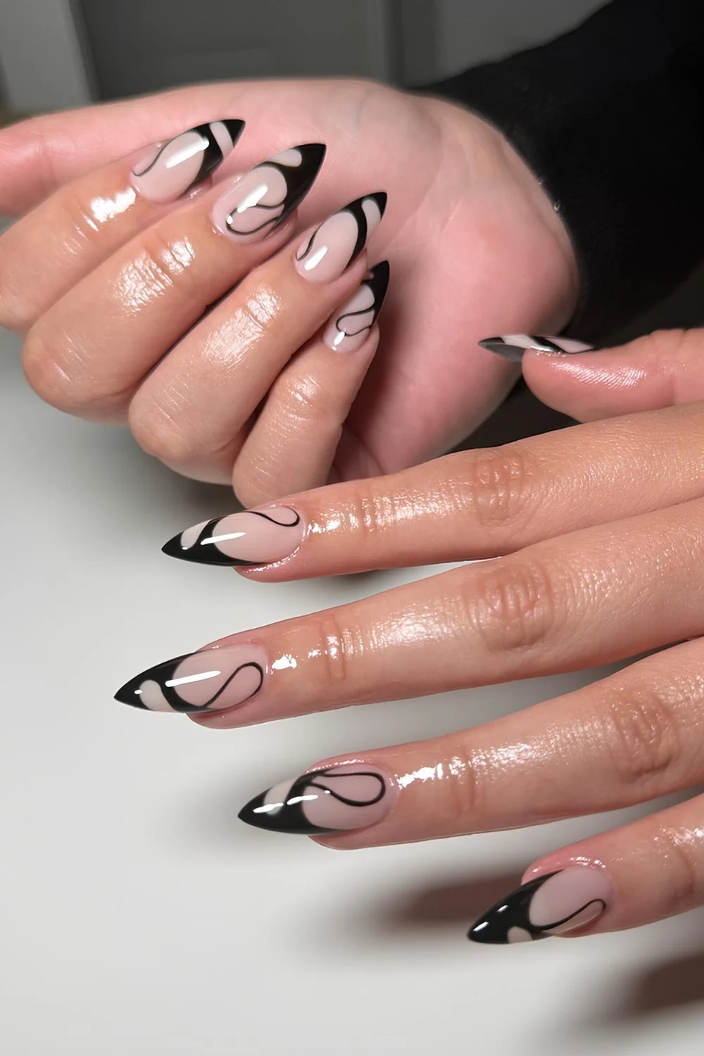 Black swirly French almond nails