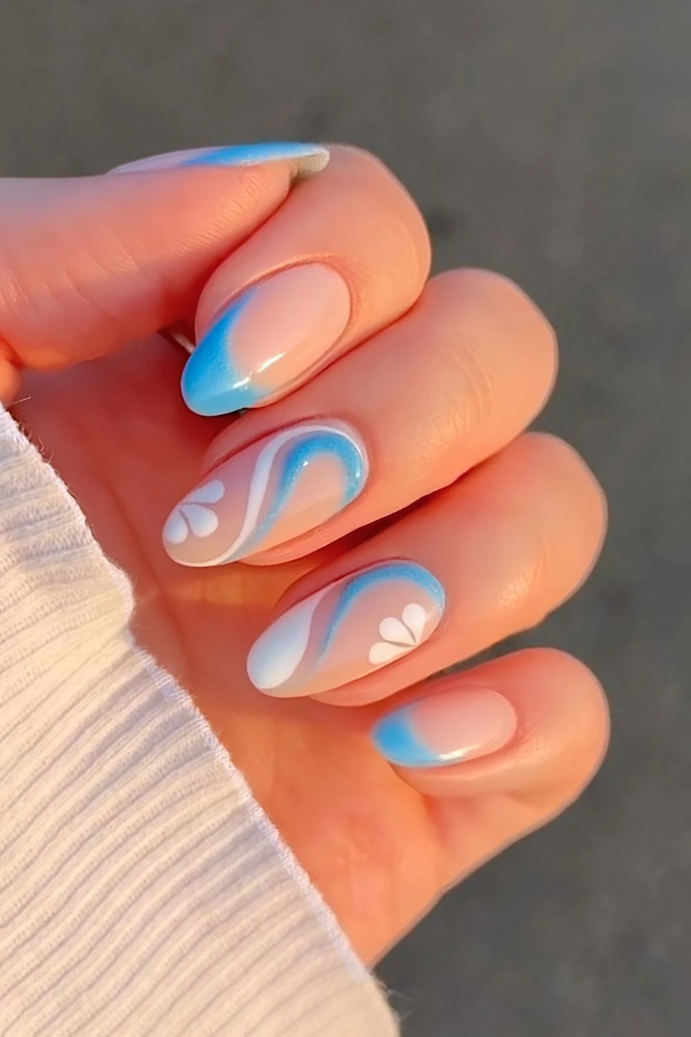 Blue French tip with white and blue swirl and floral accents