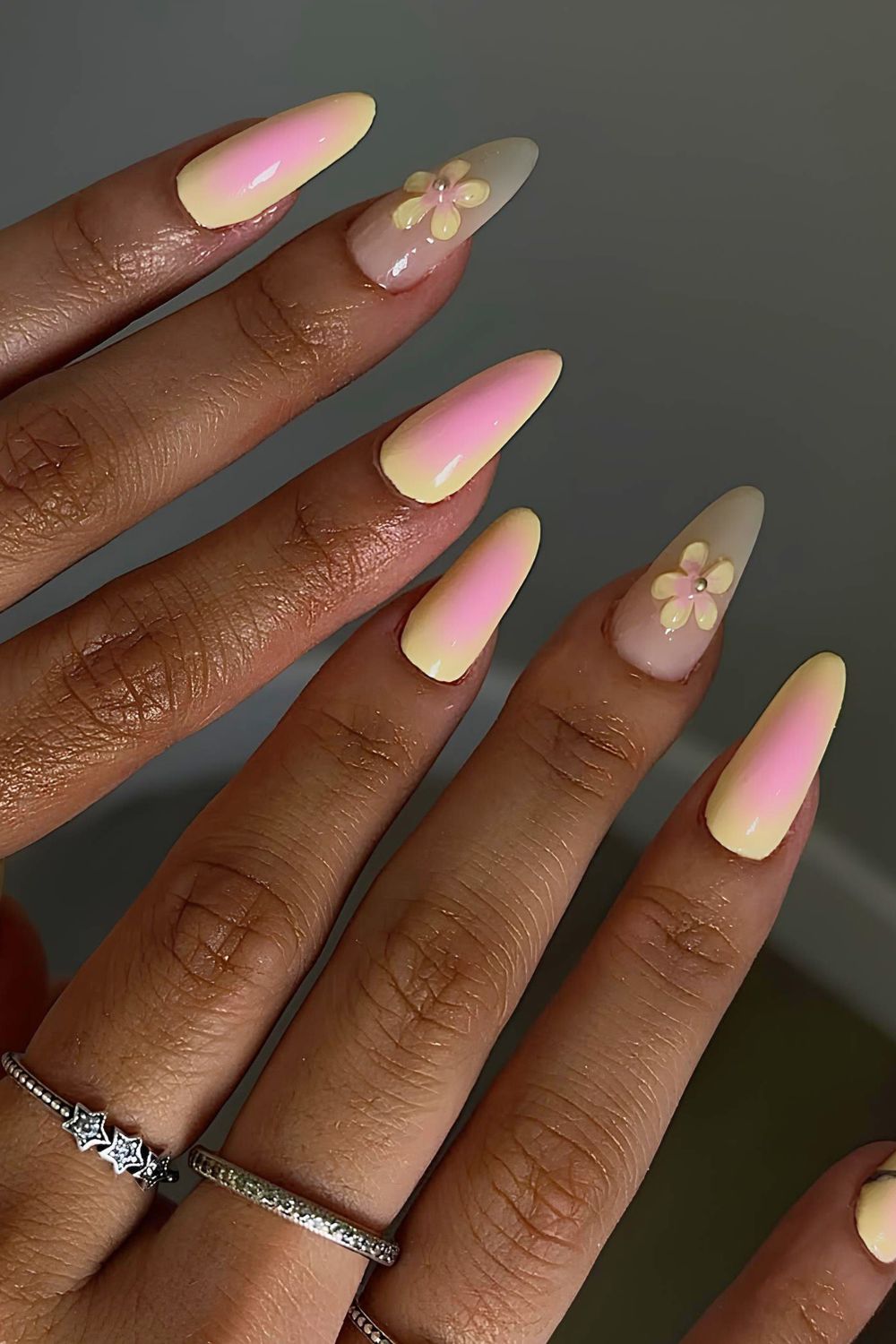 Bright yellow and pink aura nails with 3d flower