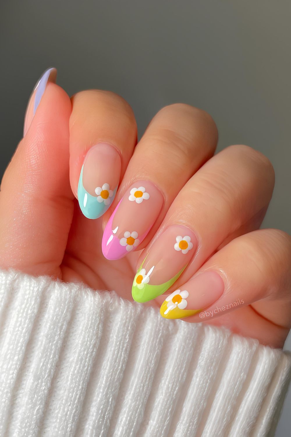 Colorful French tip nails with daisy accents