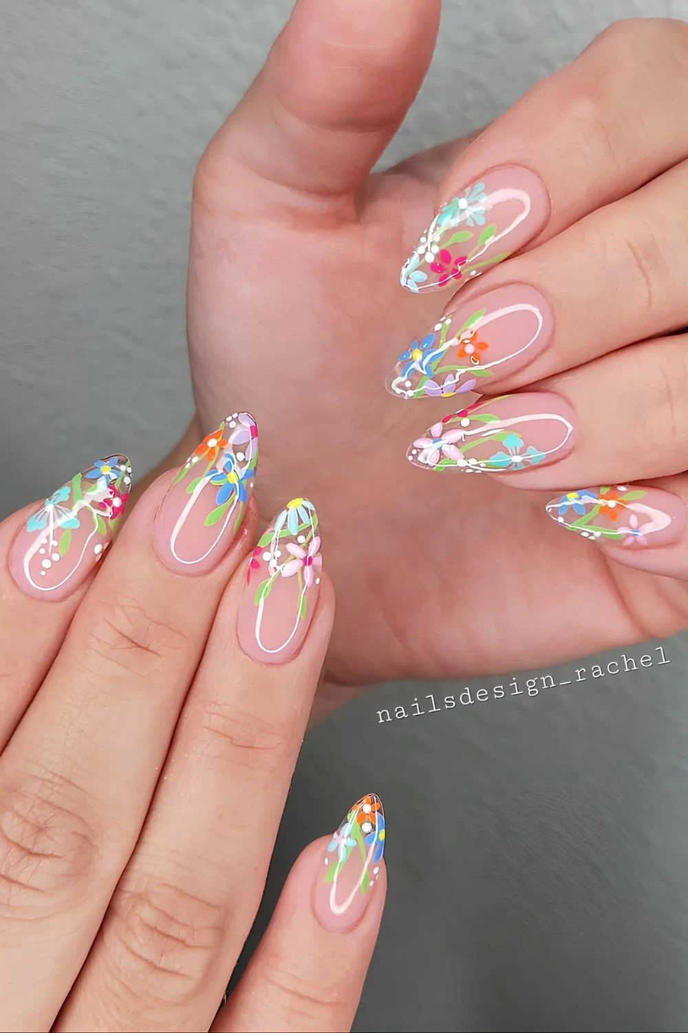 Colorful floral French tip nails with sheer base and glossy finish